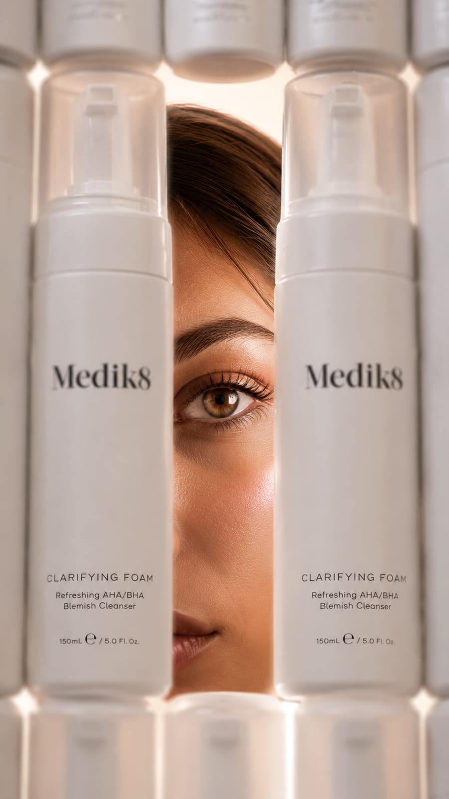Model's eye framed between rows of white skincare cleanser bottles — CampaignsLive AI digital campaign creative